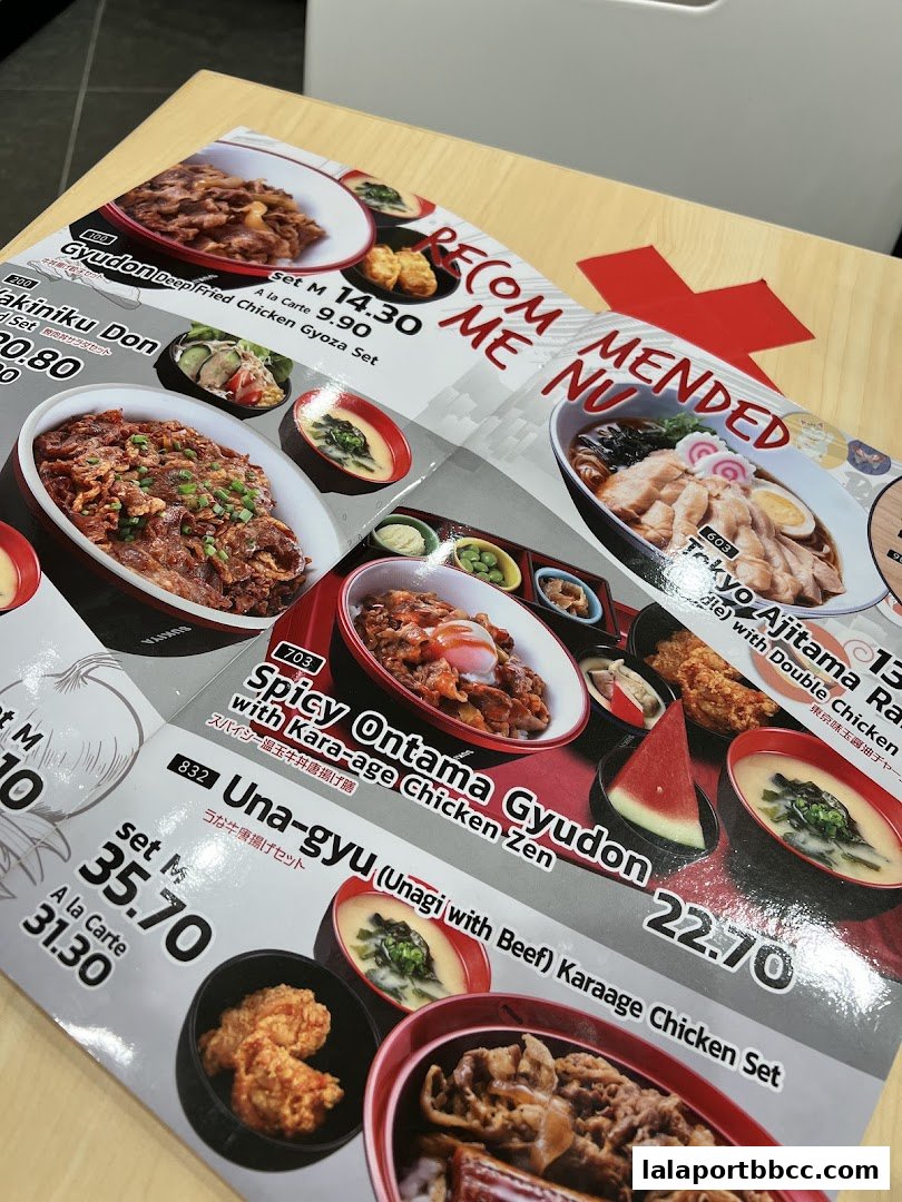A menu from Sukiya Tokyo Bowls & Noodles featuring various Japanese rice bowls and noodle dishes.