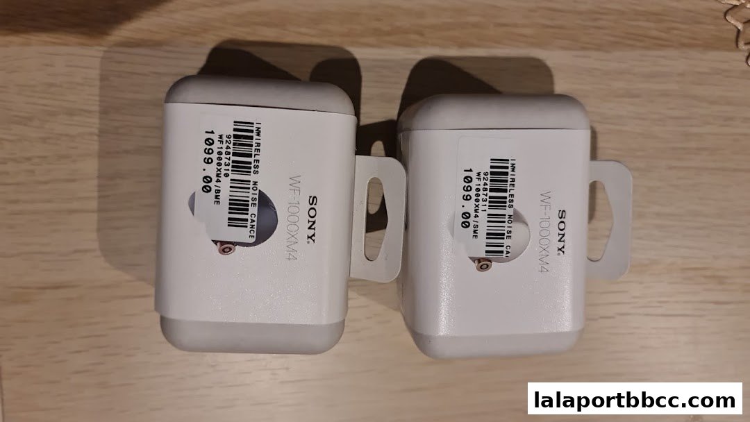 Two white Sony WF-1000XM4 wireless noise-canceling earbuds cases with price tags.