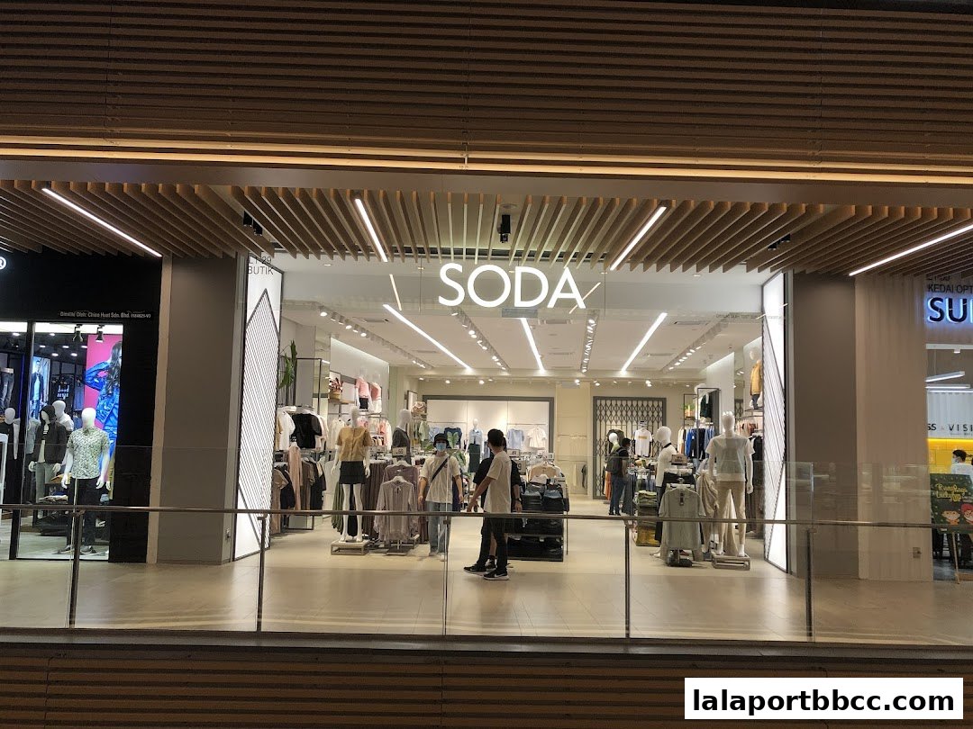 The SODA store entrance displays mannequins dressed in stylish clothing and a well-lit interior.