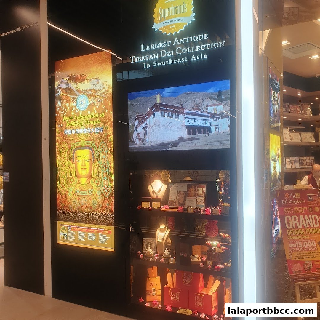 A shop display featuring Tibetan Dzi beads, jewelry, and religious imagery.
