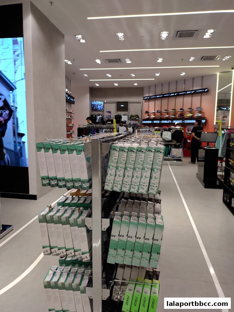 Interior view of a sports apparel store with shelves displaying branded products.
