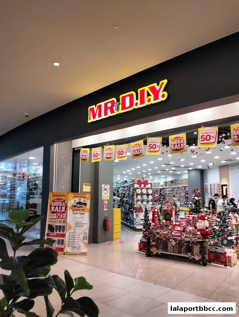 The entrance of MR.DIY PLUS shop with festive decorations and sale banners.