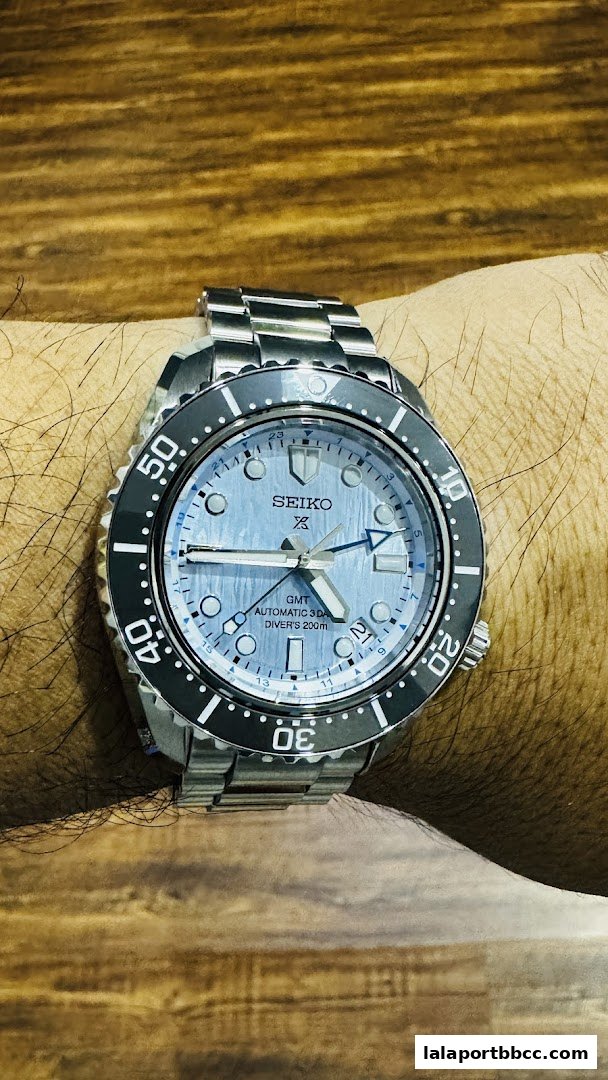 A close-up shot of a Seiko automatic GMT diver's watch on a person's wrist.