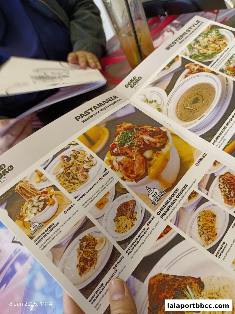 A person is looking at a menu from Doko Koko cafe with various pasta dishes.