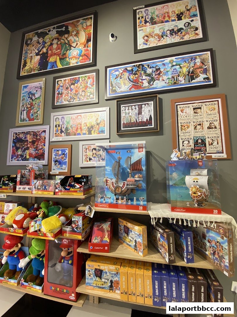 Shelves filled with anime-themed puzzles, toys, and collectibles, including One Piece and Super Mario.