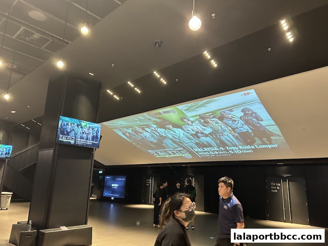 Interior view of Zepp Kuala Lumpur with a large screen displaying event information and people walking.