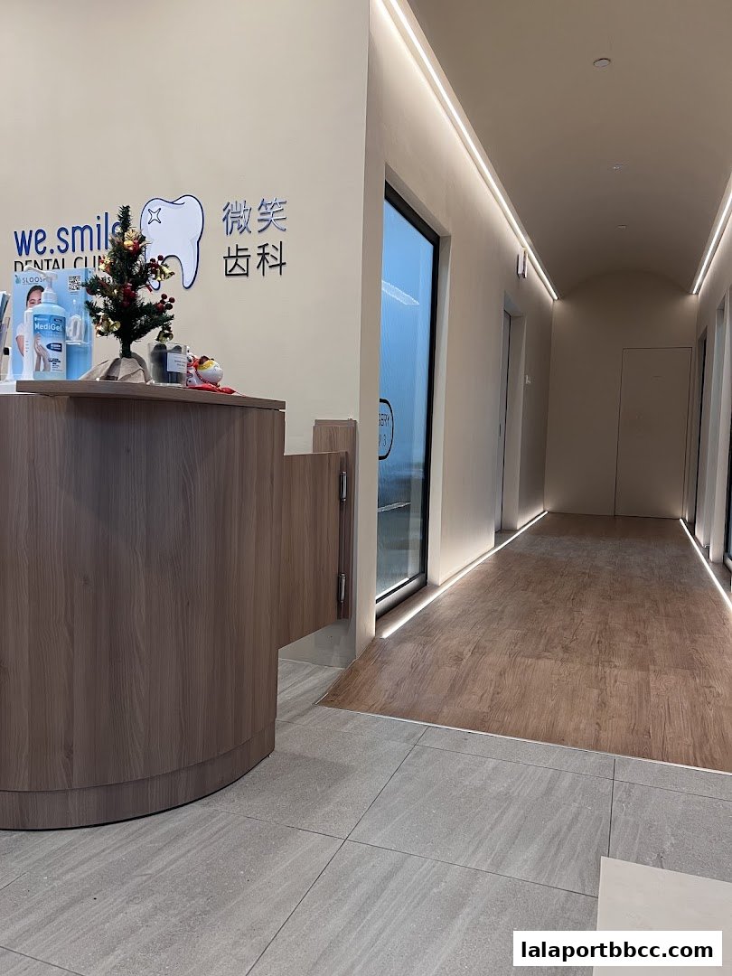 The reception area of WeSmile Dental Clinic with a wooden counter and a festive Christmas tree.