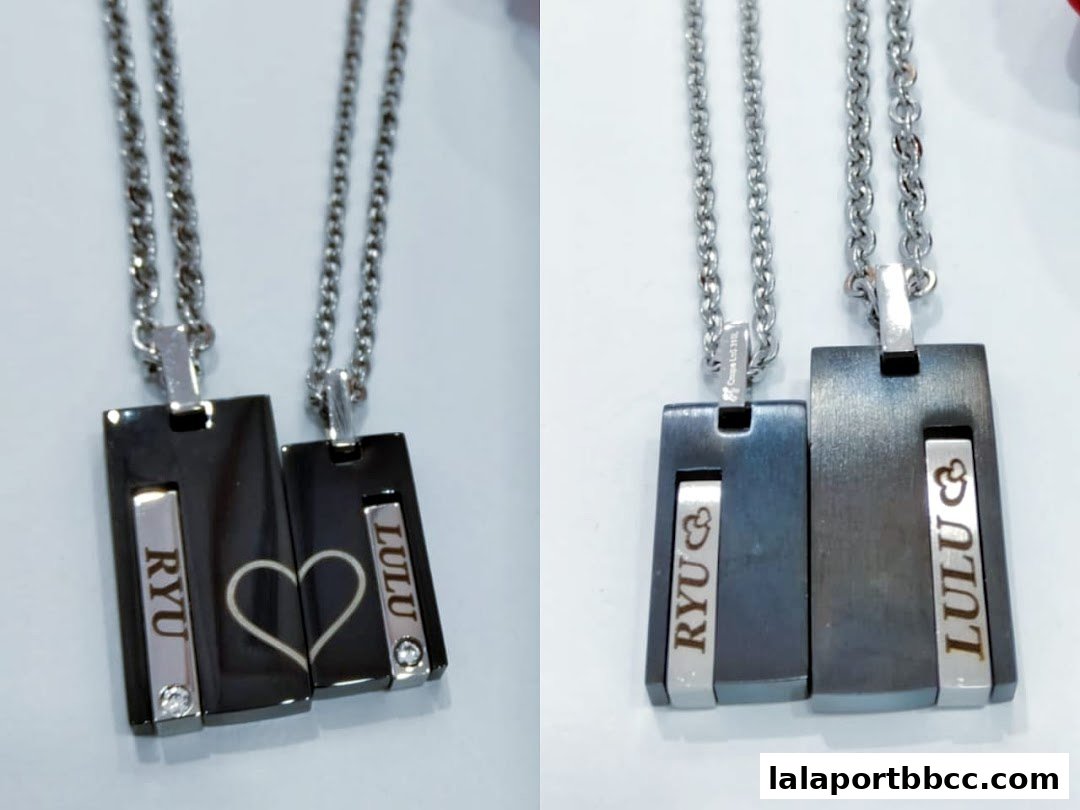 Two matching couple necklaces with personalized engravings and a heart design.