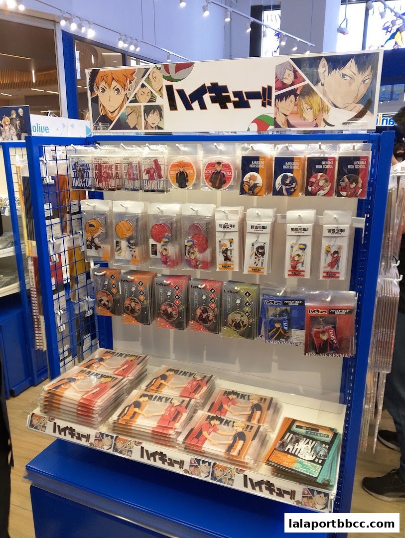 A display of merchandise featuring characters from the anime Haikyu!!, including keychains and prints.