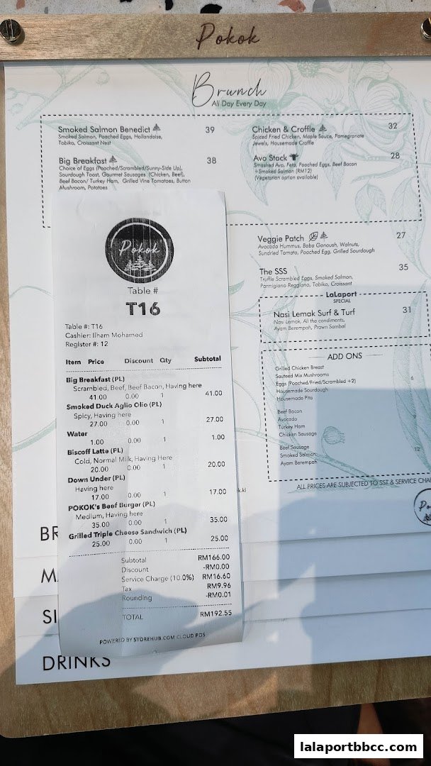 A receipt and menu from POKOK LaLaport showing brunch items and order details.
