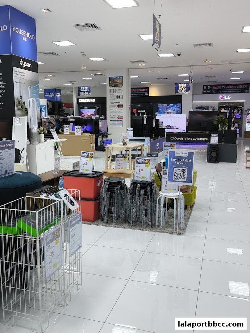 Interior view of an electronics store showcasing various appliances and televisions from brands like Dyson, Samsung, and LG.