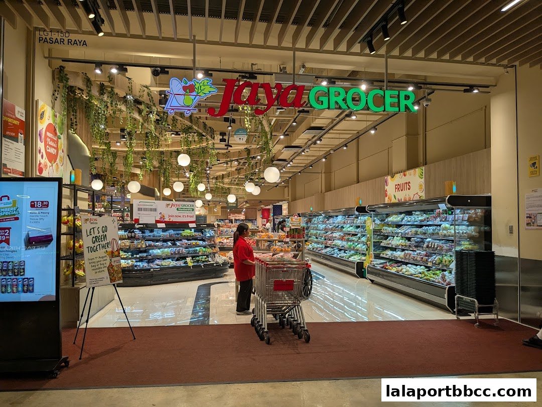 The entrance to Jaya Grocer supermarket, featuring fresh produce displays and promotional signage.