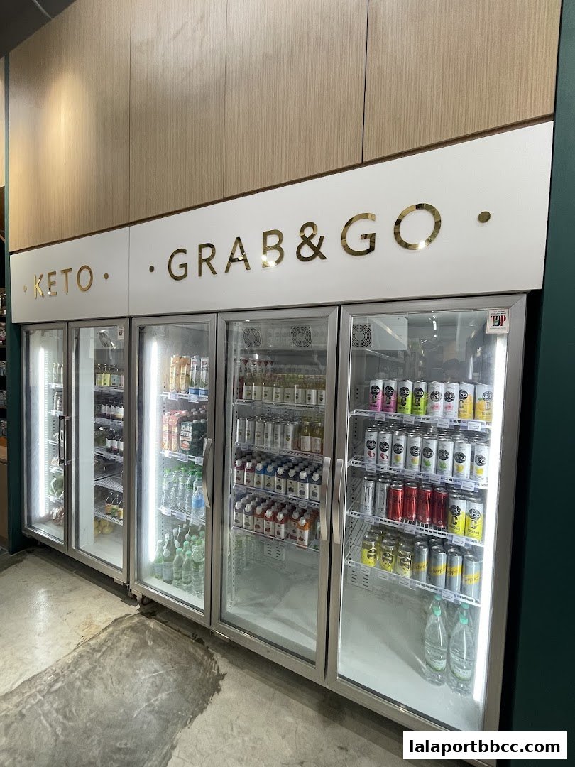 Refrigerated display cases filled with drinks and labeled 'KETO GRAB & GO'.