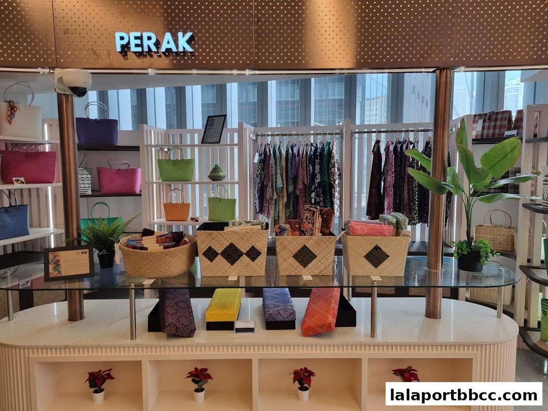 A retail display featuring colorful woven bags, clothing, and accessories.