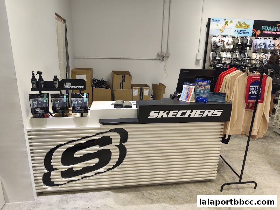 The Skechers store counter with products and clothing displayed.