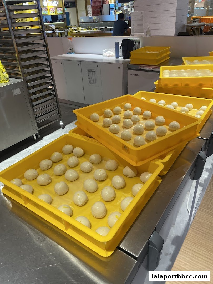Trays of freshly prepared dough balls ready for baking at Rotiboy.