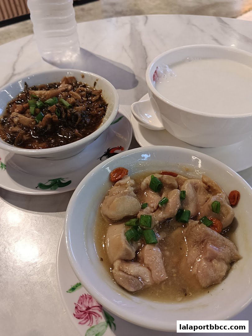 Three bowls of traditional Chinese desserts and a bottle of water on a marble table.