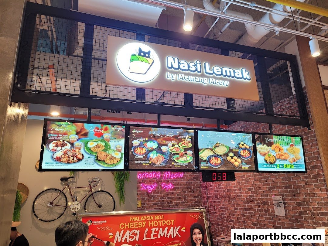 Digital menu boards displaying various Nasi Lemak dishes and promotions.