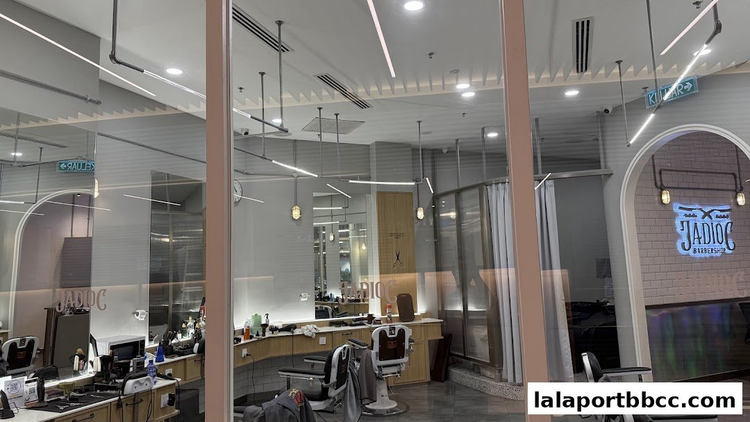Interior view of Jadioc Barbershop with barber chairs, styling stations, and branding.