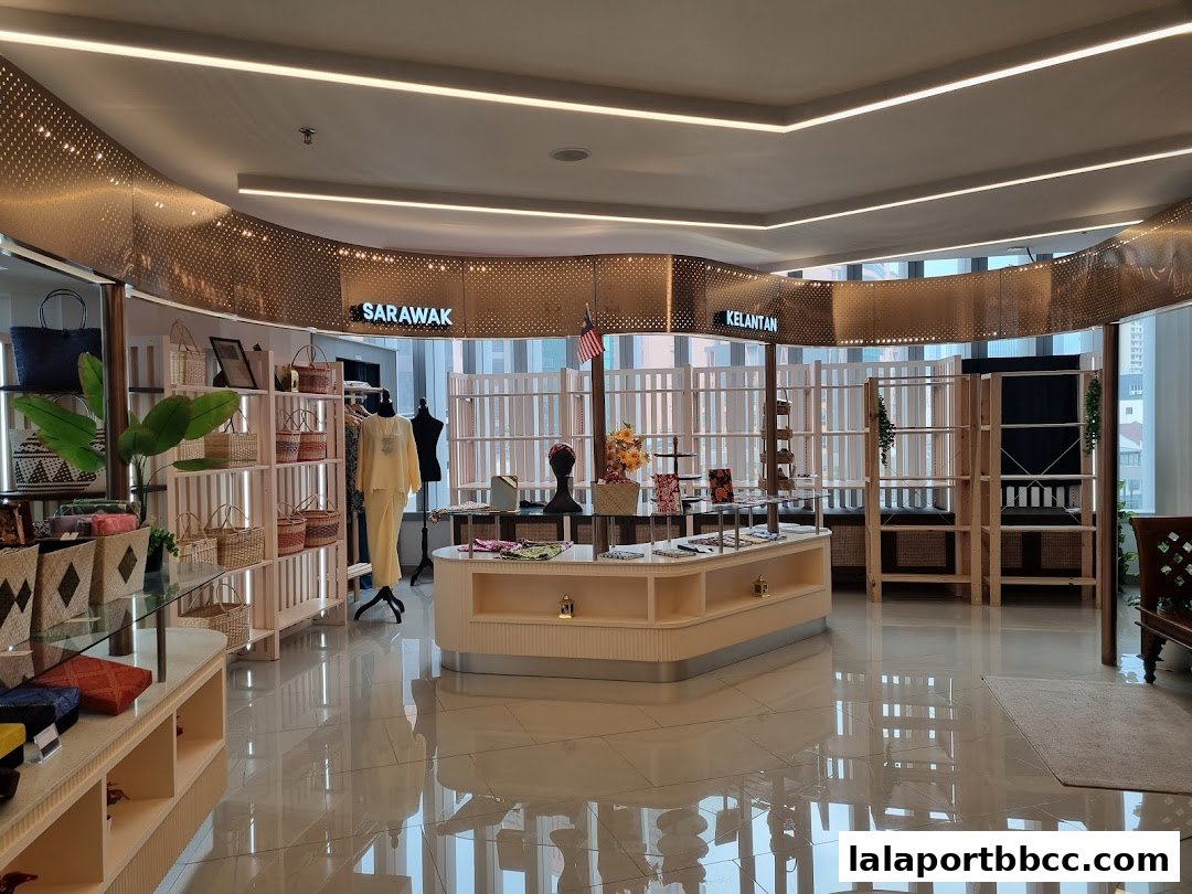 Interior view of a shop displaying traditional Malaysian crafts and clothing.
