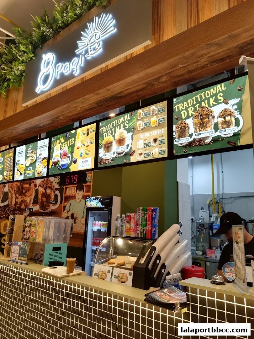 A brightly lit counter with a menu board displaying drinks and food items.