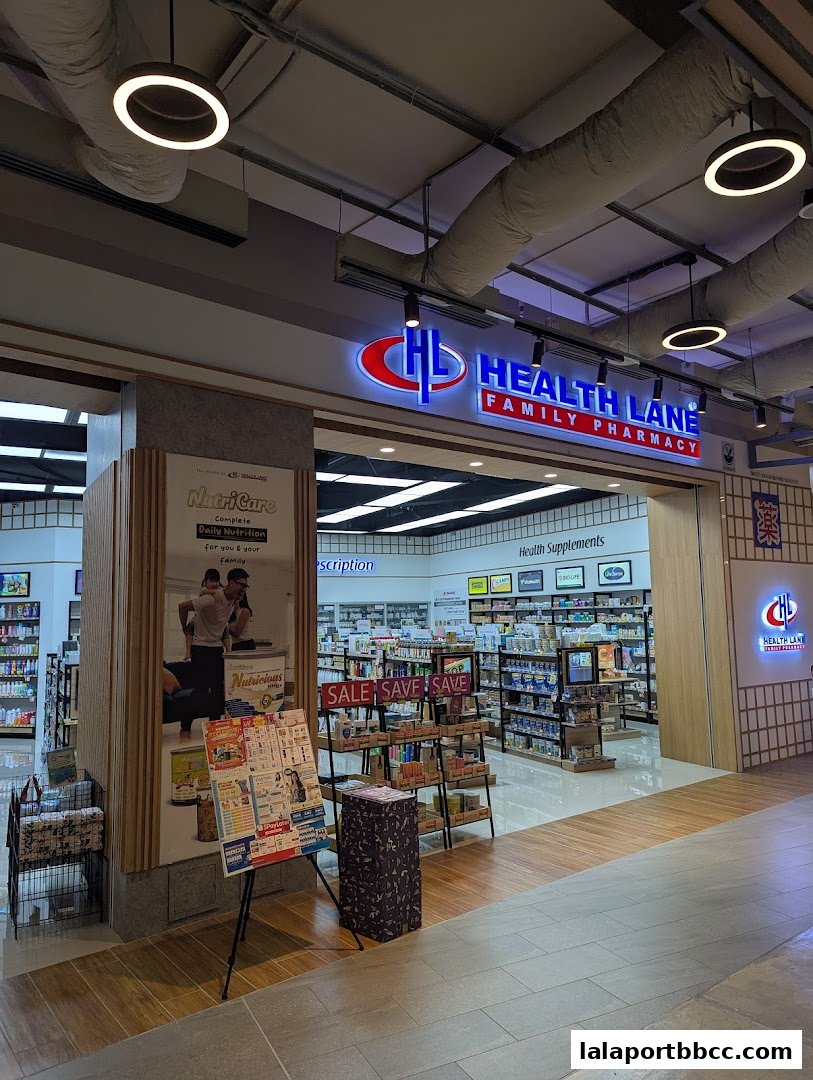 The entrance of Health Lane Family Pharmacy, showcasing shelves stocked with health products and sale signs.