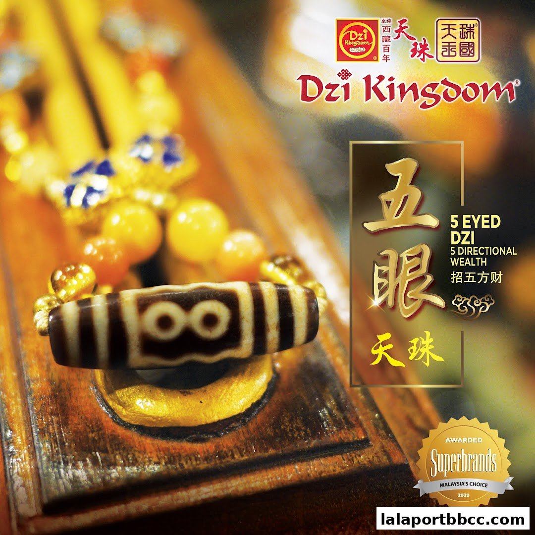 A close-up of a Dzi bead with intricate patterns, surrounded by other beads and the shop's branding.