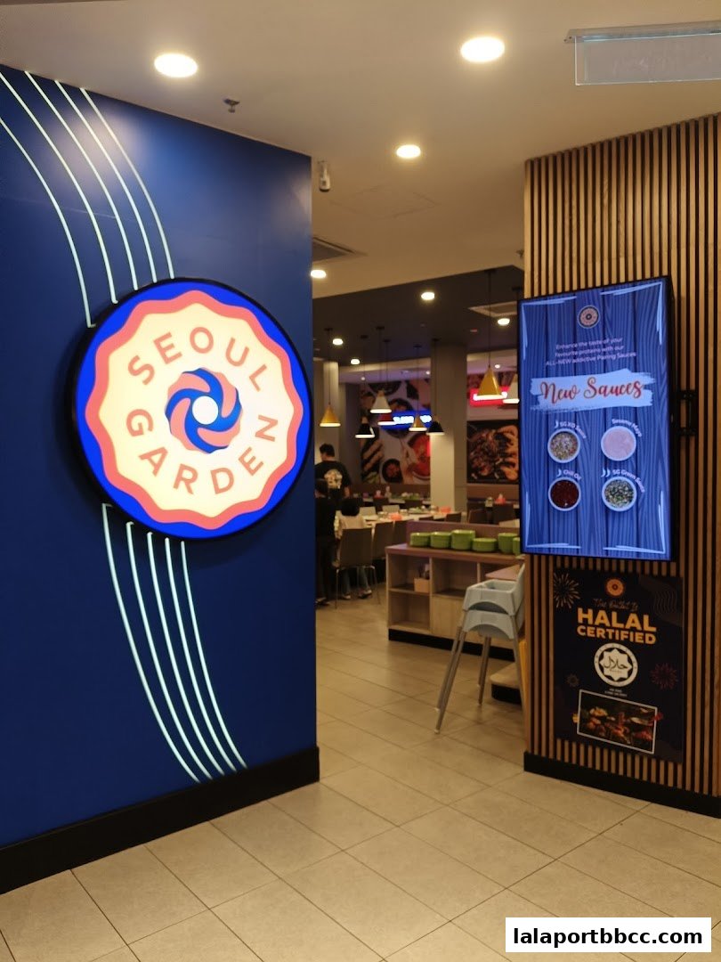 Entrance to Seoul Garden restaurant with a prominent logo and a digital menu display.