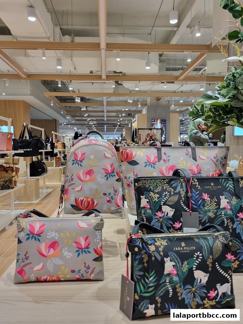 A display of stylish handbags and backpacks with floral and animal prints.