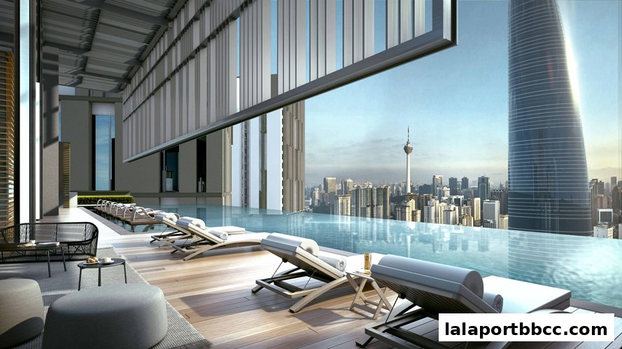 Luxurious infinity pool with lounge chairs overlooking a city skyline and modern architecture.
