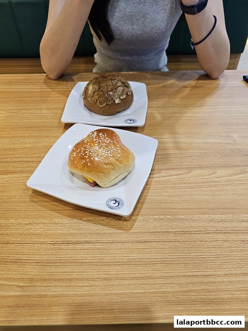 A person sits at a table with two delicious-looking pastries from Taste of Hong Kong.