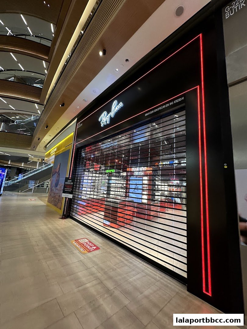 The Ray-Ban store front with its signature logo and a closed roller shutter.