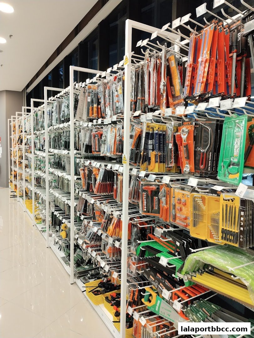 A wide aisle of a MR.DIY PLUS store showcasing a vast selection of tools and hardware.