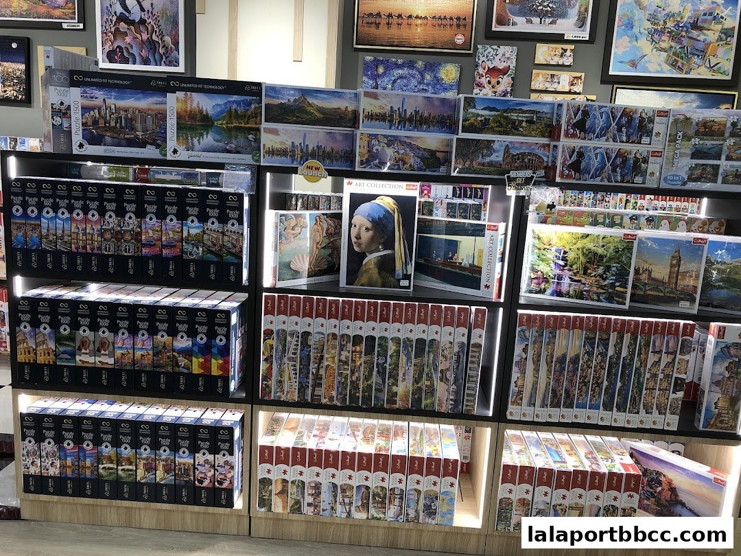 Shelves filled with various jigsaw puzzles featuring scenic landscapes and famous artworks.