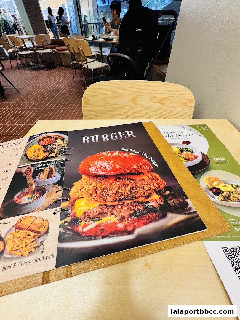 A menu featuring a large burger and other dishes, with a QR code visible.