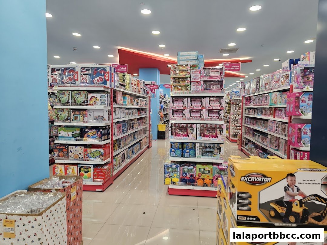 Interior view of a brightly lit toy store with shelves stocked with various toys.
