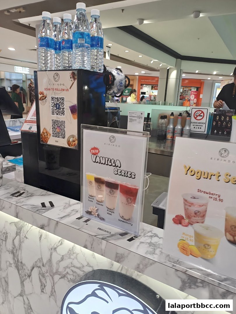 A Kirindo shop counter displaying new Vanilla and Yogurt series drinks with prices.
