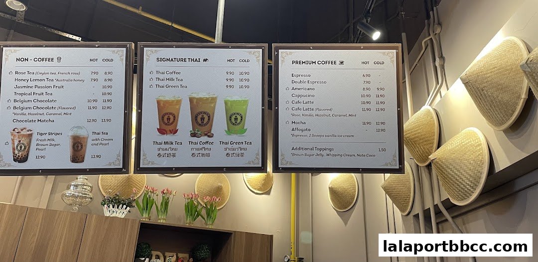 A menu board displaying various coffee and tea options with prices.