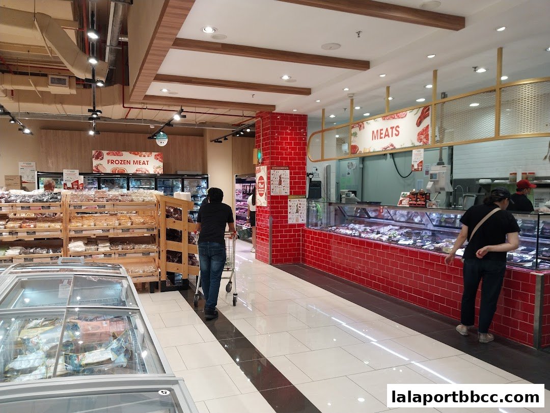 Interior view of Jaya Grocer at LaLaport BBCC, showcasing fresh meats and frozen food sections.