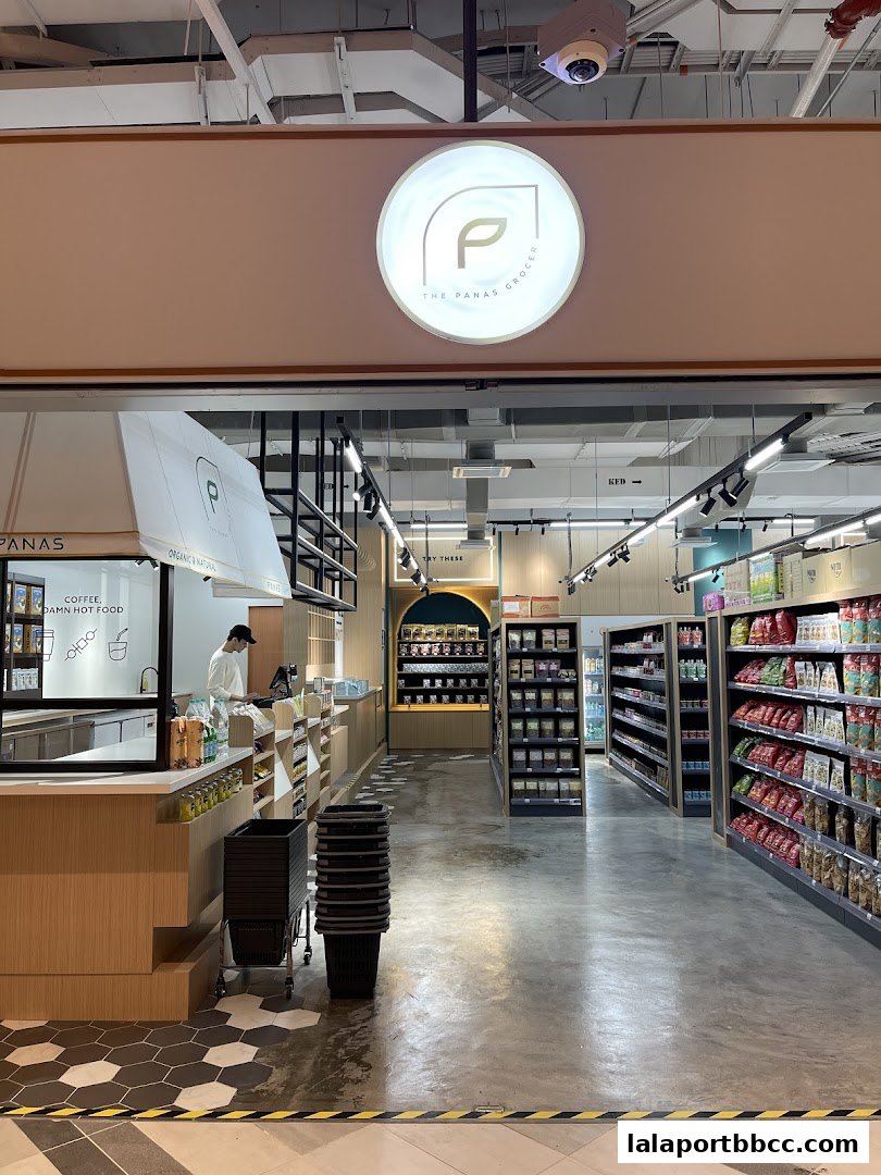 Interior view of The Panas Grocer, showcasing shelves stocked with products and a service counter.