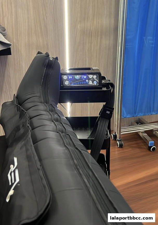 A person's legs are encased in compression boots connected to a control unit.