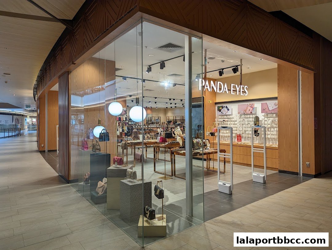 The exterior of the Panda Eyes shop, showcasing handbags and accessories through its glass facade.