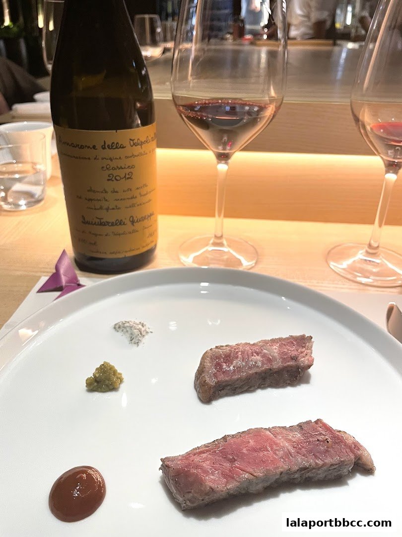 A plate of sliced steak with condiments and a bottle of wine.