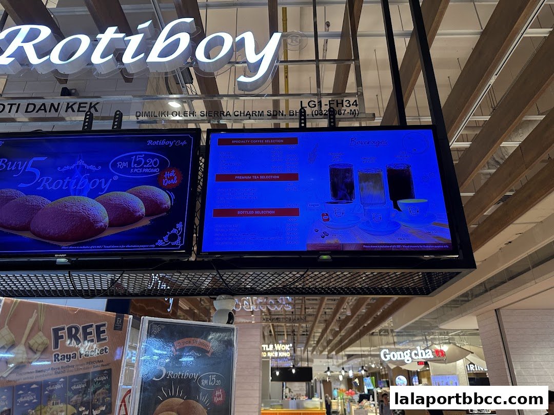 Digital menu boards displaying Rotiboy promotions and beverage selections.