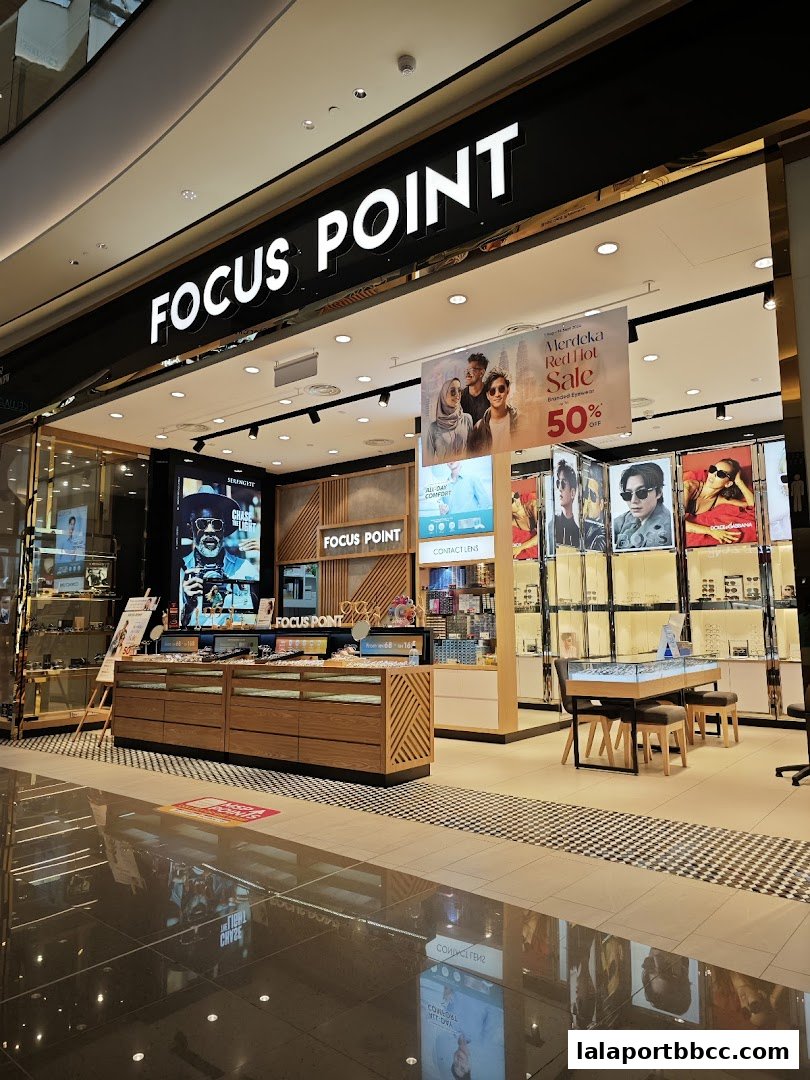 The exterior of a Focus Point optical shop with a large sign and displays of eyewear.
