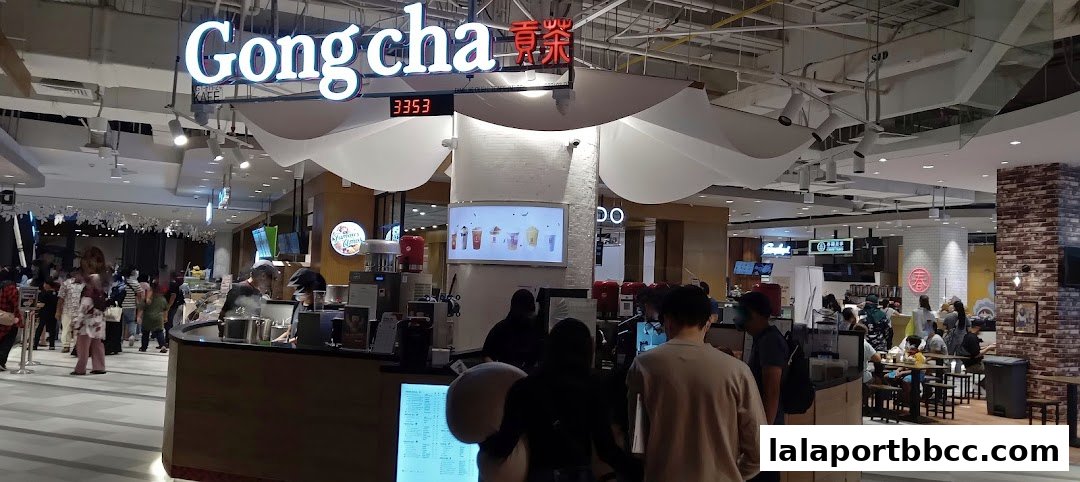 A busy food hall with a Gong Cha bubble tea stall and other eateries.