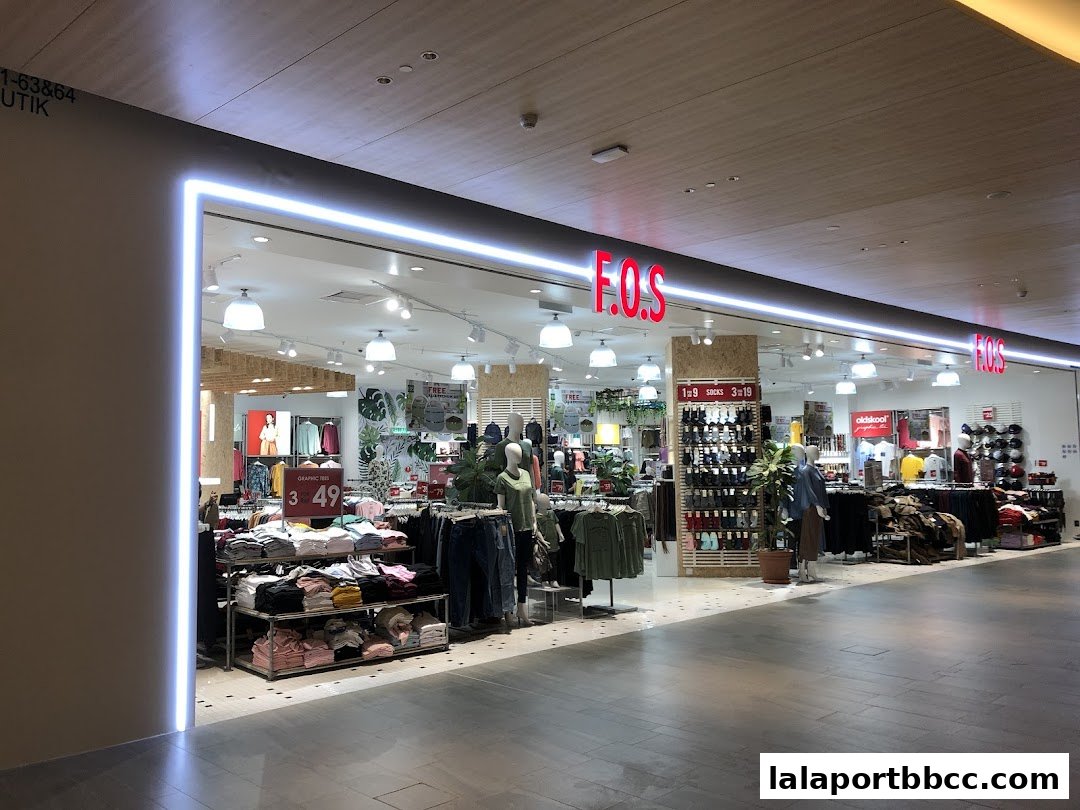 The F.O.S. clothing store entrance with displays of apparel and promotional signage.
