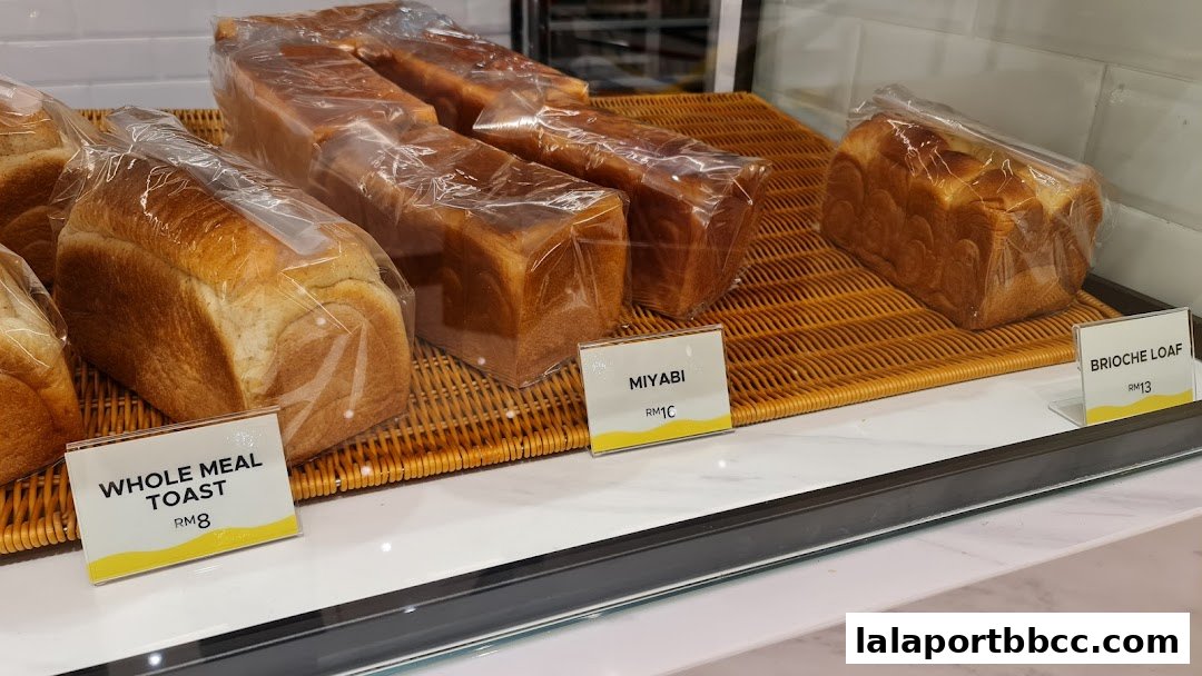 Freshly baked loaves of bread displayed in a bakery case.
