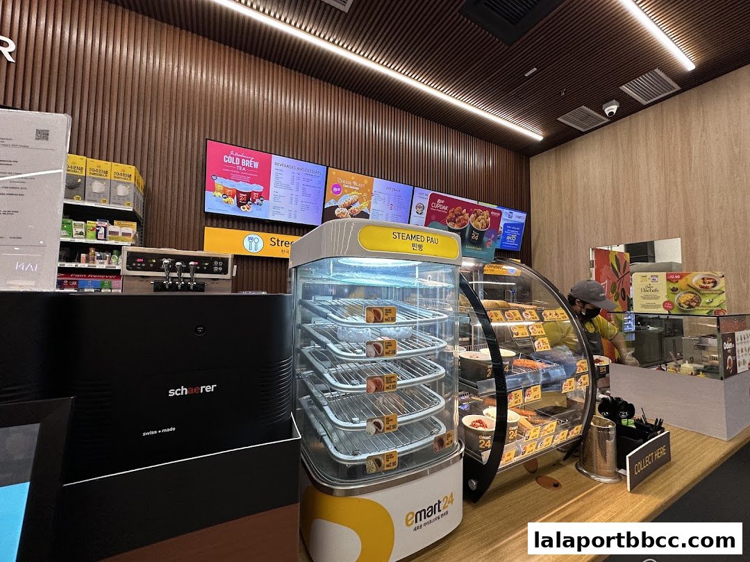 Interior view of an emart24 convenience store with food displays and a coffee machine.