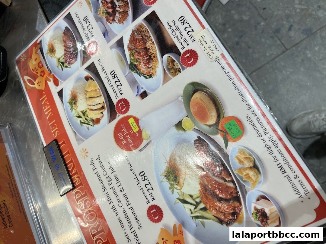 A menu featuring various chicken rice sets and side dishes with prices.